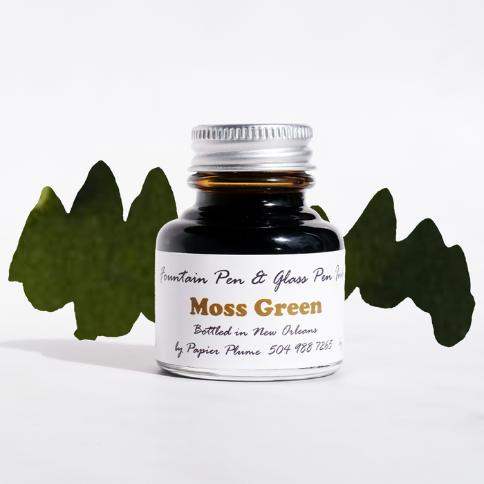 Moss green fountain pen ink in a Papier Plume ink bottle, showcasing the rich, earthy color for writing and calligraphy.