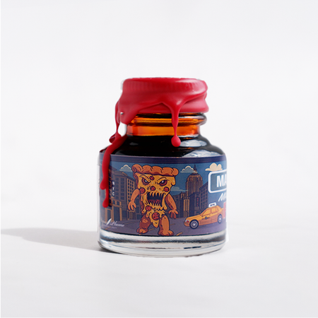 Papier Plume Manhattan Man-Eating Pizza fountain pen ink bottle with colorful label and ink inside, perfect for writing and calligraphy.