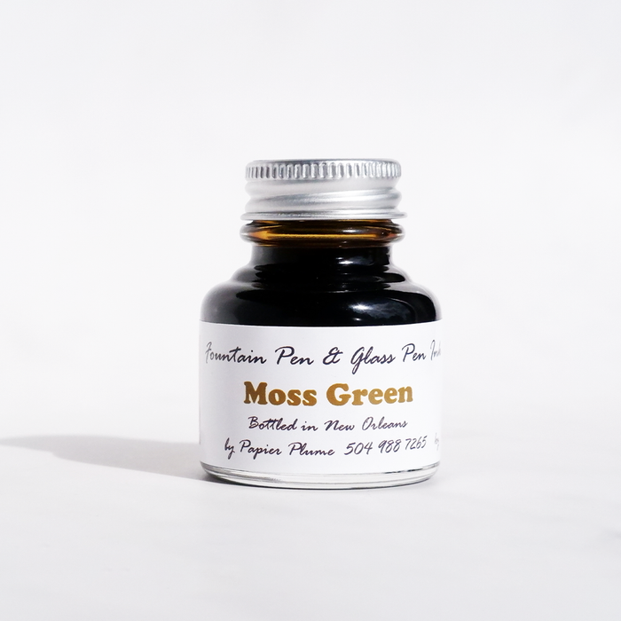 Moss Green fountain pen ink in a Papier Plume bottle, showcasing rich green ink for elegant writing.