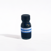 Papier Plume Pavo Real fountain pen ink bottle with vibrant blue and green ink in a clear glass container.