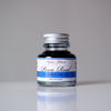 Papier Plume Pavo Real fountain pen ink bottle with vibrant blue and green ink, featuring a decorative label.