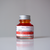Papier Plume Plaquemines fountain pen ink bottle with vibrant ink inside, designed for elegant writing and calligraphy.