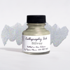 Bottled metallic silver calligraphy ink by Papier Plume with a sleek silver ink bottle and calligraphy nibs on a white background.