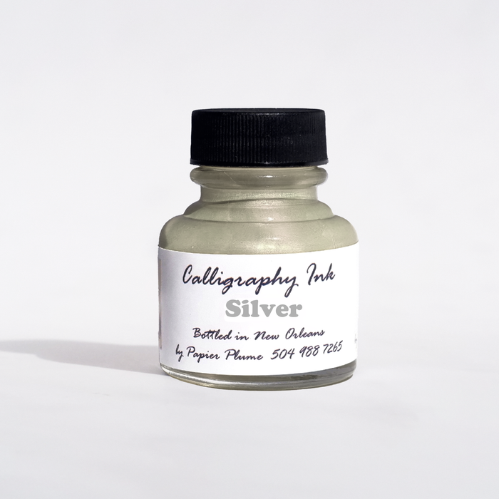 Silver metallic calligraphy ink bottle by Papier Plume, featuring elegant ink for artistic writing and lettering projects.