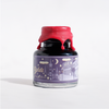 Papier Plume Southern Nights shimmer fountain pen ink in a glass bottle with vibrant blue and purple hues.