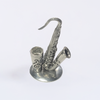 Le Potier D'Étain pewter saxophone-shaped pen rest stand for quill or pens, featuring detailed craftsmanship and a smooth finish.