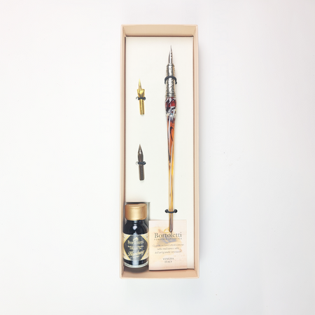 Bortoletti glass dipping pen set with 20 amber-colored pens, showcasing elegant and artistic writing tools.