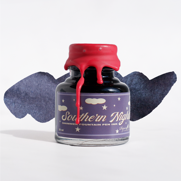 Swatch of Papier Plume Southern Nights shimmer fountain pen ink showing deep blue with shimmering accents.