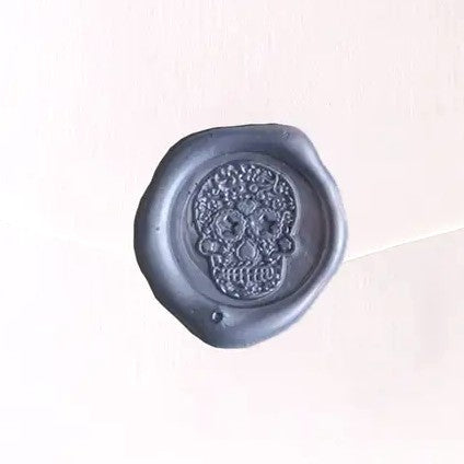 Brass wax seal stamp with intricate symbol design, used for sealing documents and adding a decorative touch.