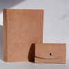 Swatch Books set by Papier Plume featuring tan-colored swatch book with fabric and paper samples visible.