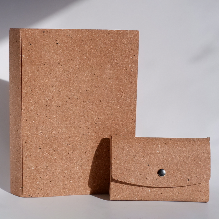 Swatch Books set by Papier Plume featuring tan-colored swatch book with fabric and paper samples visible.