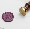 Papier Plume wax seal featuring elegant V-script monogram on cream-colored sealing wax for vintage-style correspondence.