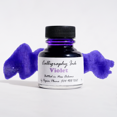 Violet bottled calligraphy ink from Papier Plume, showcasing a glass bottle with vibrant purple ink for artistic lettering.