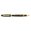 Esterbrook Estie fountain pen with gold fittings, displayed in a botanical gardens setting, showcasing elegant writing instrument design