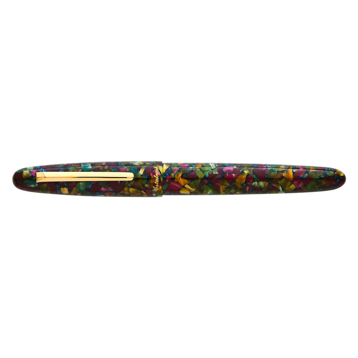 Esterbrook Estie fountain pen with gold fittings resting on a botanical garden background, showcasing its elegant design and detailing.