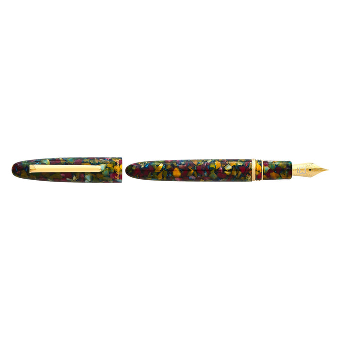 Esterbrook Estie fountain pen with gold fittings, displayed in a botanical gardens setting, showcasing elegant writing instrument design