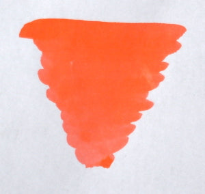 Bright coral fountain pen ink in a Diamine bottled ink container, showcasing vibrant, smooth-flowing ink for writing and calligraphy.