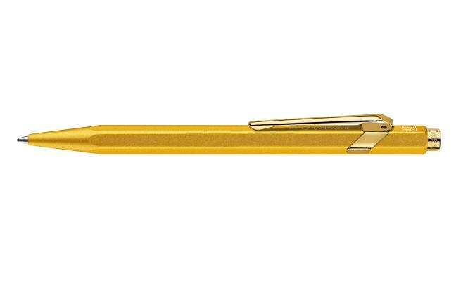 Gold Caran D'Ache Ballpoint Pen 849 with sleek design, displayed with its protective case.