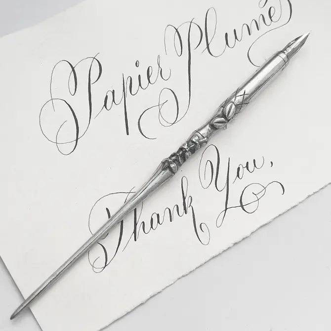 Le Potier D'etain pewter dip calligraphy pen with fleur-de-lys design, ideal for elegant writing and artistic calligraphy projects.