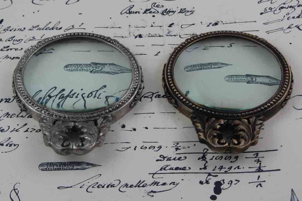 Large Le Potier D'etain pewter magnifying glass with handle and acanthus design, perfect for detailed viewing or decorative use.