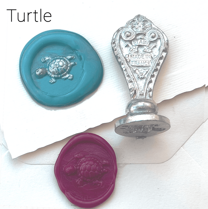 Le Potier D'etain wax seal with anchor design, showcasing detailed craftsmanship on a golden wax seal for sealing letters.