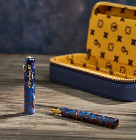 Close-up of an Esterbrook Niblet fountain pen nib showing fine gold tip and engraved branding on a sleek black pen body.