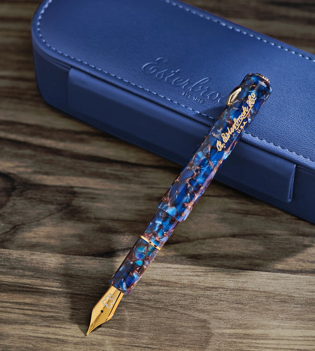 Esterbrook Niblet fountain pen with a sleek black body and gold accents, featuring a close-up of the fine nib.