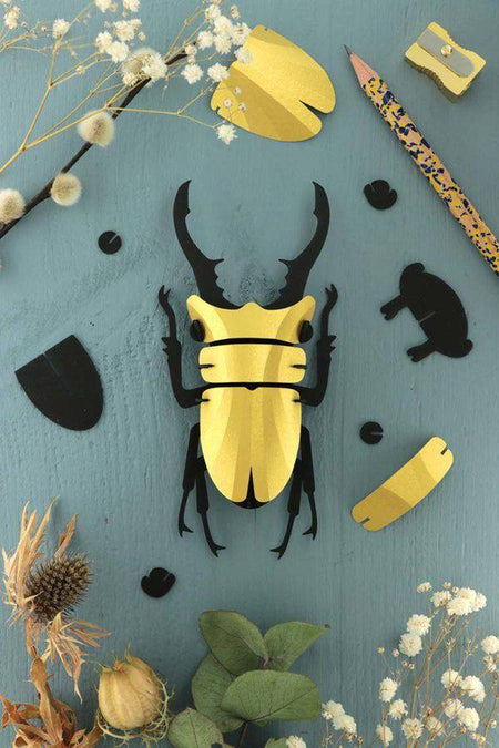 Small Paper Stag Beetle craft by Assembli with green metallic paper, showcasing detailed insect design for creative projects.