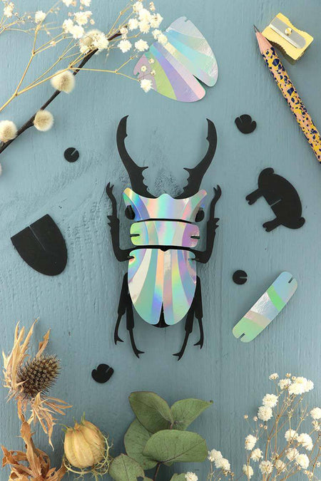 Small Paper Stag Beetle craft by Assembli in Caribbean green metallic paper, showcasing detailed insect design for creative projects.