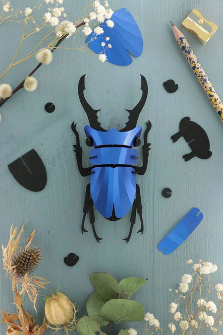 Small Paper Stag Beetle craft by Assembli in Caribbean green metal paper, featuring detailed wings and antennae.