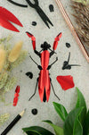 Assembli Paper Praying Mantis craft made of red metal and paper, showcasing detailed insect sculpture for arts and crafts projects.