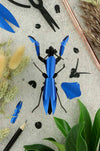 Ruby red paper praying mantis craft made of metal and paper, created by Assembli, showcasing intricate handmade details.