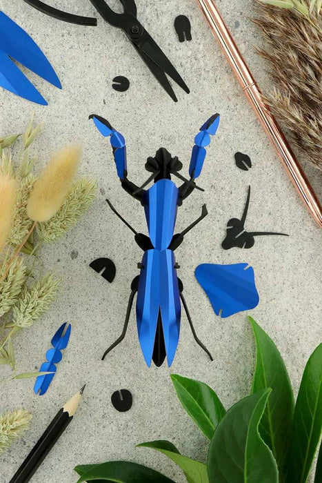 Ruby red paper praying mantis craft made of metal and paper, created by Assembli, showcasing intricate handmade details.