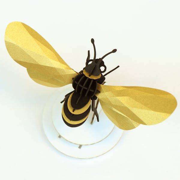 Gold satin paper craft of a honey bee made from Assembli Paper Honey Bee craft kit, showcasing detailed bee design and textured gold paper.