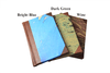 Small handcrafted leather-trimmed journal with marbled paper pages and modern spine, featuring lined pages in turquoise.