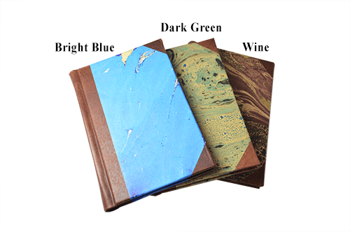 Small handcrafted leather-trimmed journal with marbled paper pages and modern spine, featuring lined pages in turquoise.