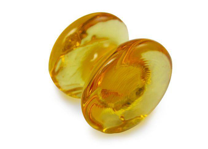 Amber glass pen rest by Papier Plume, featuring a smooth, curved design to hold pens securely on a desk.