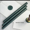 Black pliable sealing wax sticks by Papier Plume, 7 inches long, used for sealing envelopes and decorative craft projects.