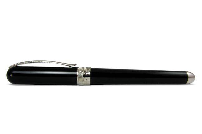 Pineider Avatar UR fountain pen in Graphene Black with gold accents, showcasing its sleek, elegant design and fine nib.