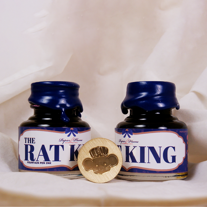 Limited edition Papier Plume Rat King fountain pen ink in a glass bottle, showcasing deep, rich ink color and elegant packaging.