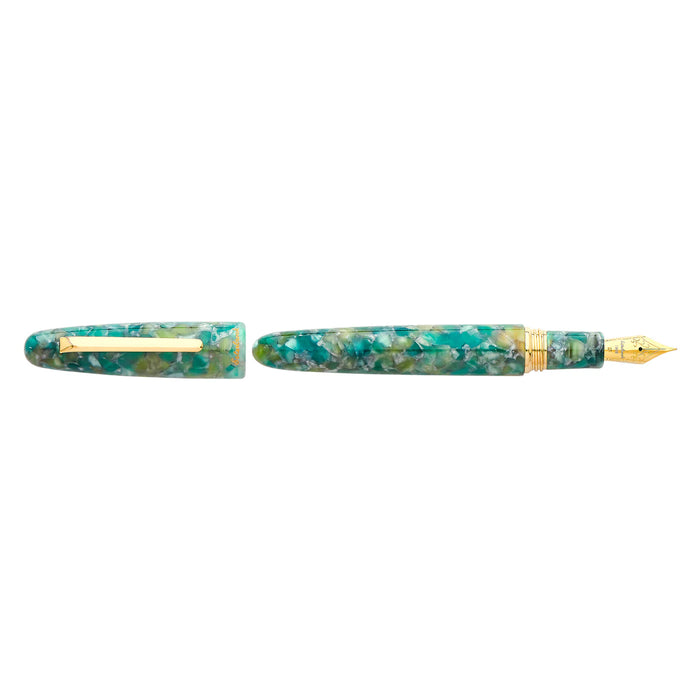 Esterbrook Estie fountain pen with sea glass body and gold fittings, showcasing its elegant design and smooth writing tip.