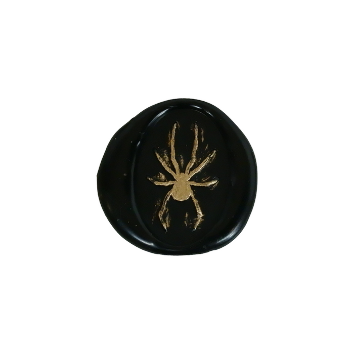 Papier Plume Halloween wax seal featuring a detailed spider design on a dark background.