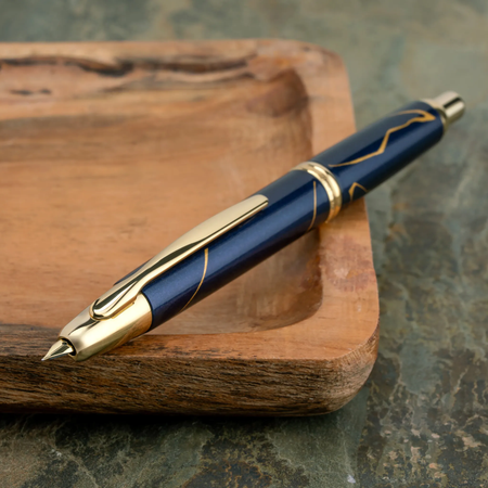 Pilot Vanishing Point Golden Journey limited edition fountain pen with gold accents and sleek black body.