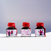 Papier Plume New Orleans Collection fountain pen ink bottle with vibrant ink inside, displayed on a white background.